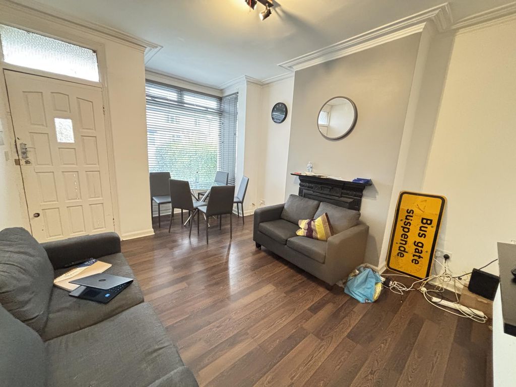 Property photo 2 of 24 A Well-Lit And Inviting Living Room With Comfortab...