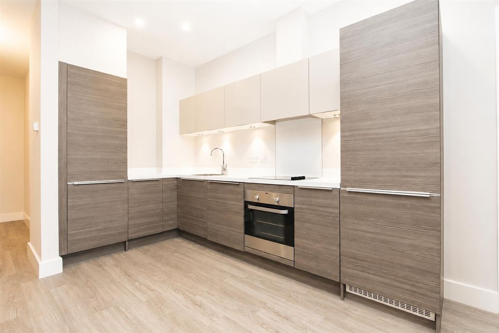 Property photo 3 of 7 Modern Kitchen With Sleek Cabinetry And Lighting...