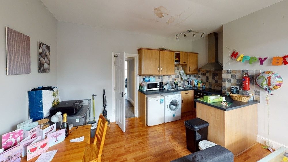 Property photo 3 of 10 A Spacious And Well-Lit Living Room Featuring Mode...