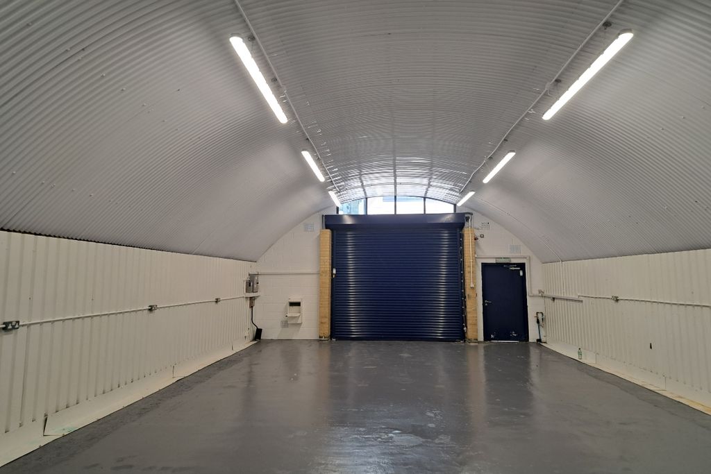 Property photo 2 of 4 An Empty Arch With White Lining, Facing The Front Electric Roller Shutter Entrance, Which Is Closed.