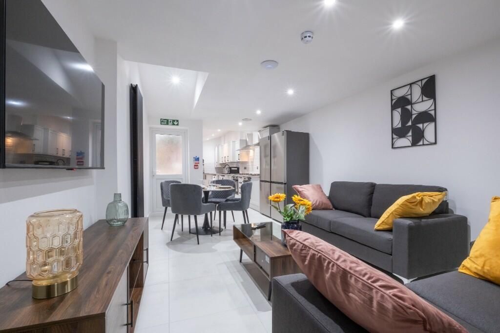 Property photo 3 of 14 A Modern, Well-Lit Living Room Featuring A Comfort...