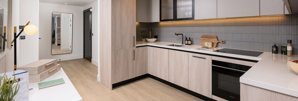 Property photo 3 of 5 Modern Kitchen With Wood Flooring, Light Brown Cupboard Surfaces, Beige Countertops