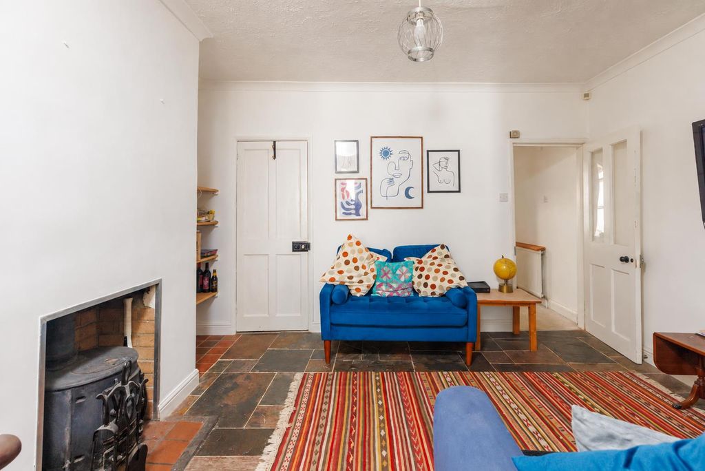 Property photo 1 of 23 Eclectic Living Room With Blue Loveseat And Globe.