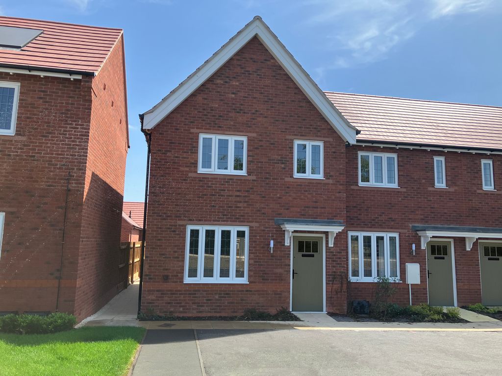 Property photo 1 of 8 A Row Of Modern Brick Townhouses With White-Framed Windows And Red Tile Roofs Stands Under A Bright