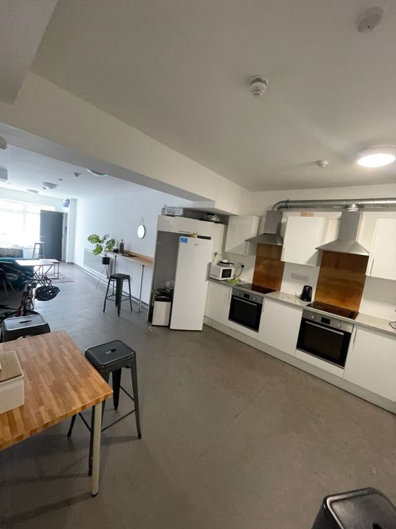 Property photo 2 of 6 Spacious And Modern Kitchen Featuring Sleek White ...