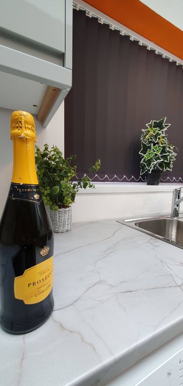 Property photo 3 of 6 A Modern Kitchen Featuring Sleek Marble Countertop...