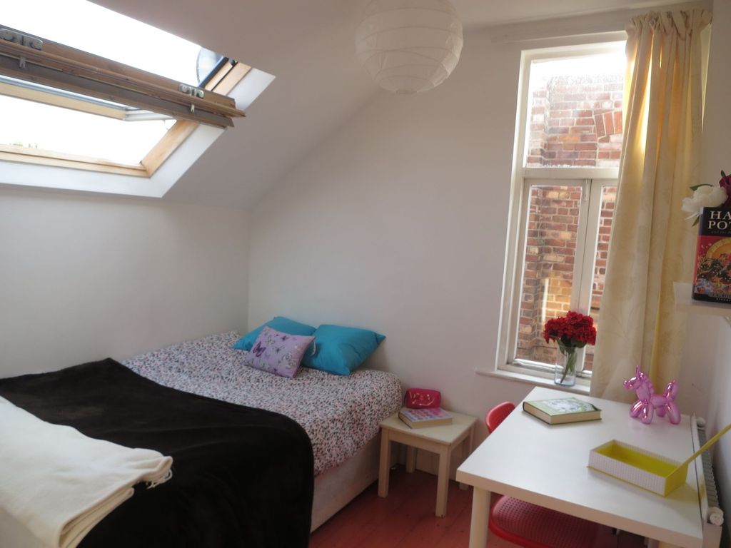 Property photo 3 of 14 Bright And Cozy Bedroom Featuring Natural Light Fr...