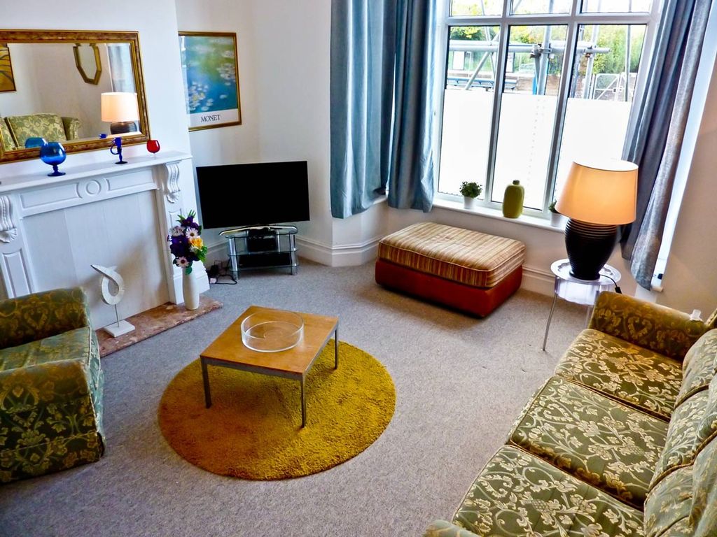 Property photo 1 of 5 A Cozy And Inviting Living Room Featuring Stylish ...