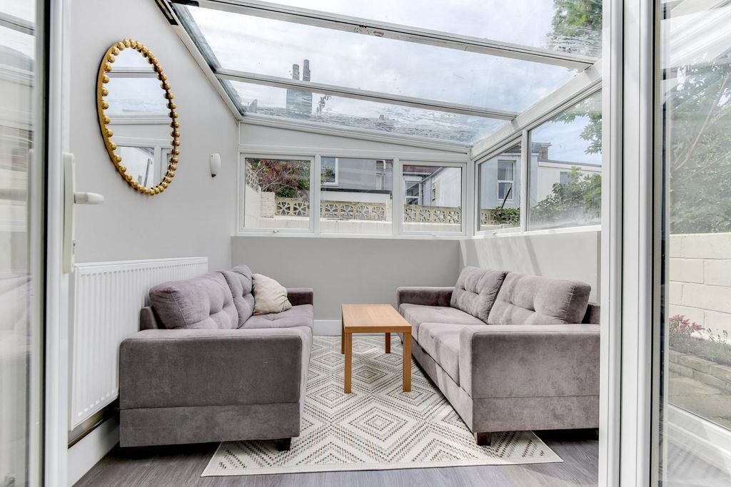 Property photo 1 of 30 A Bright And Welcoming Living Room With Large Wind...