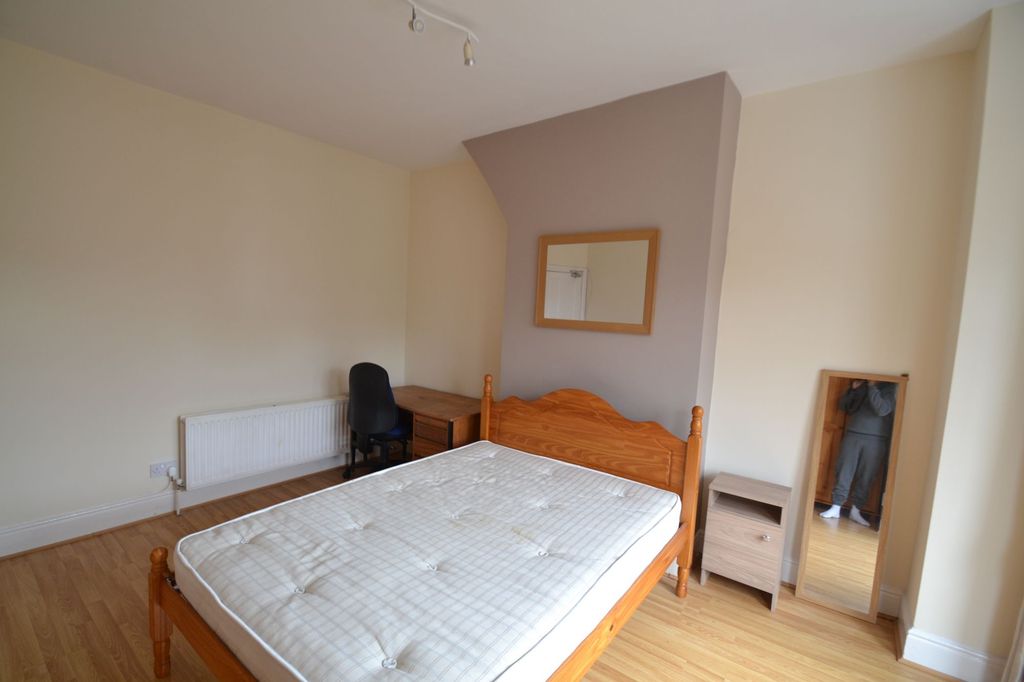 Property photo 2 of 20 Bright And Tidy Bedroom Featuring A Wooden Bed Fra...