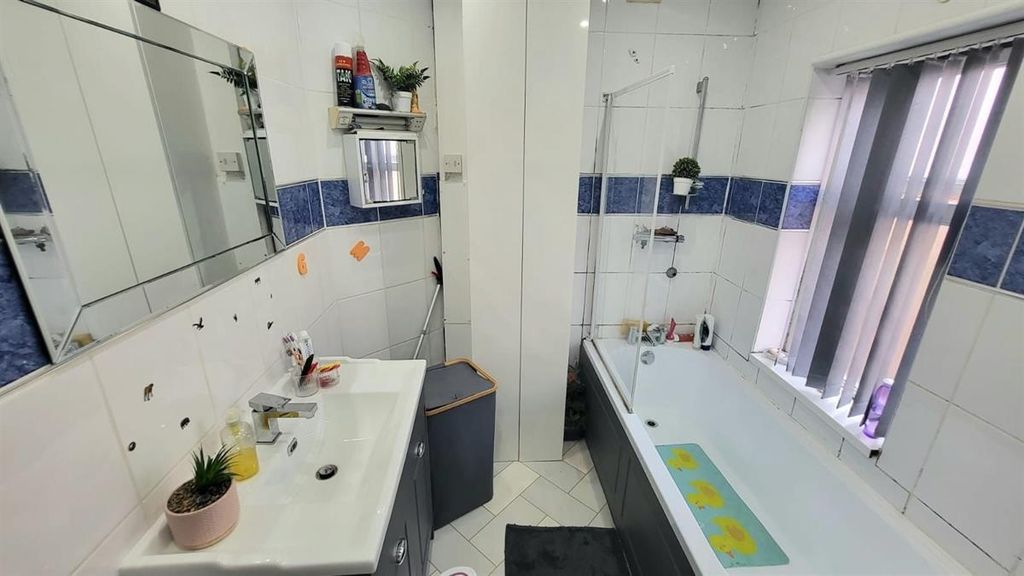 Property photo 3 of 4 Bright And Clean Bathroom Featuring A Large Bathtu...