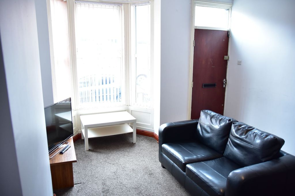 Property photo 2 of 7 A Bright And Inviting Living Room Featuring A Larg...