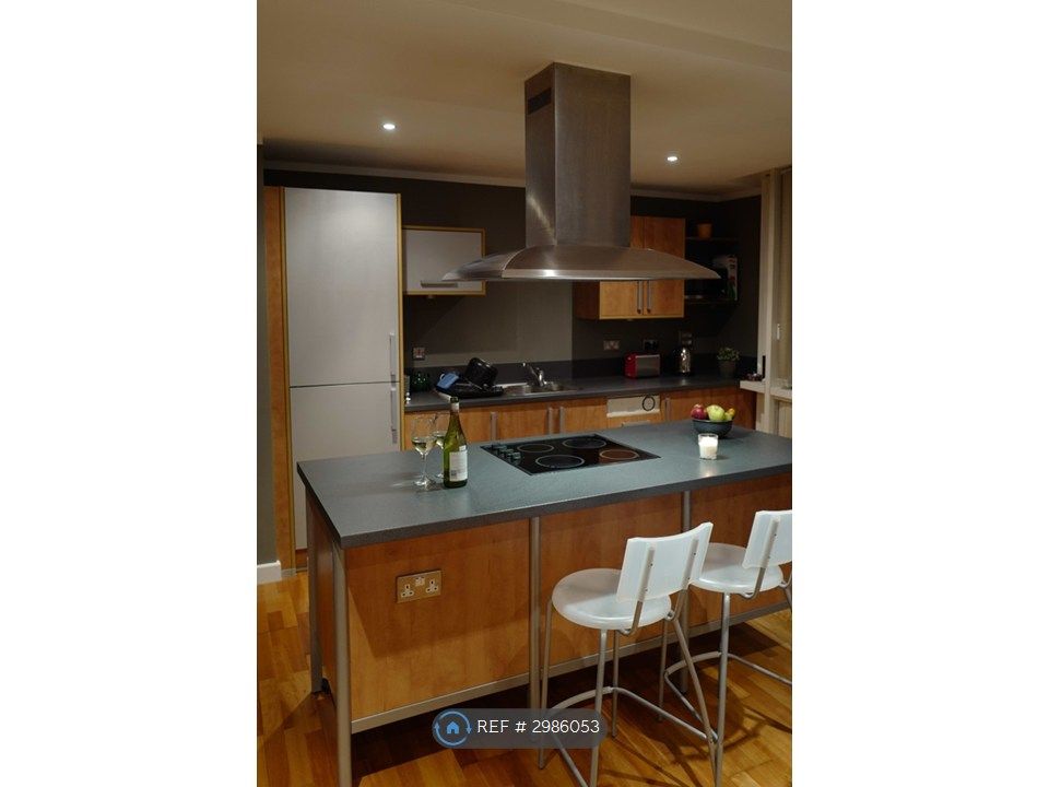 Property photo 3 of 14 Kitchen With Island And Breakfast Bar