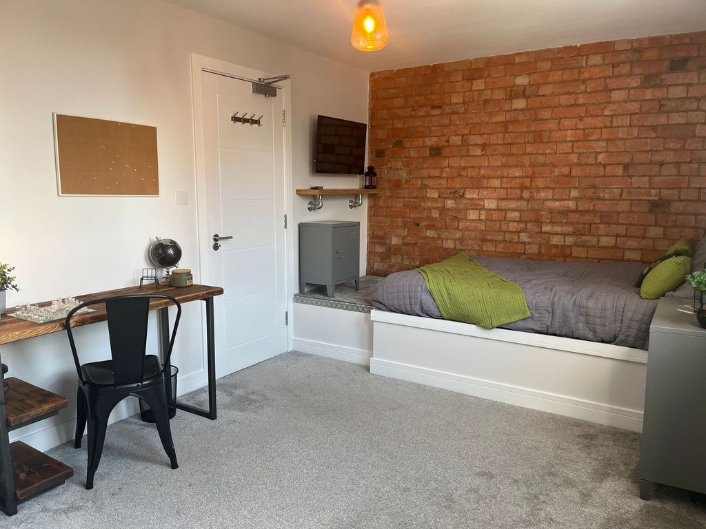 Property photo 2 of 7 A Modern, Well-Lit Bedroom Featuring A Comfortable...