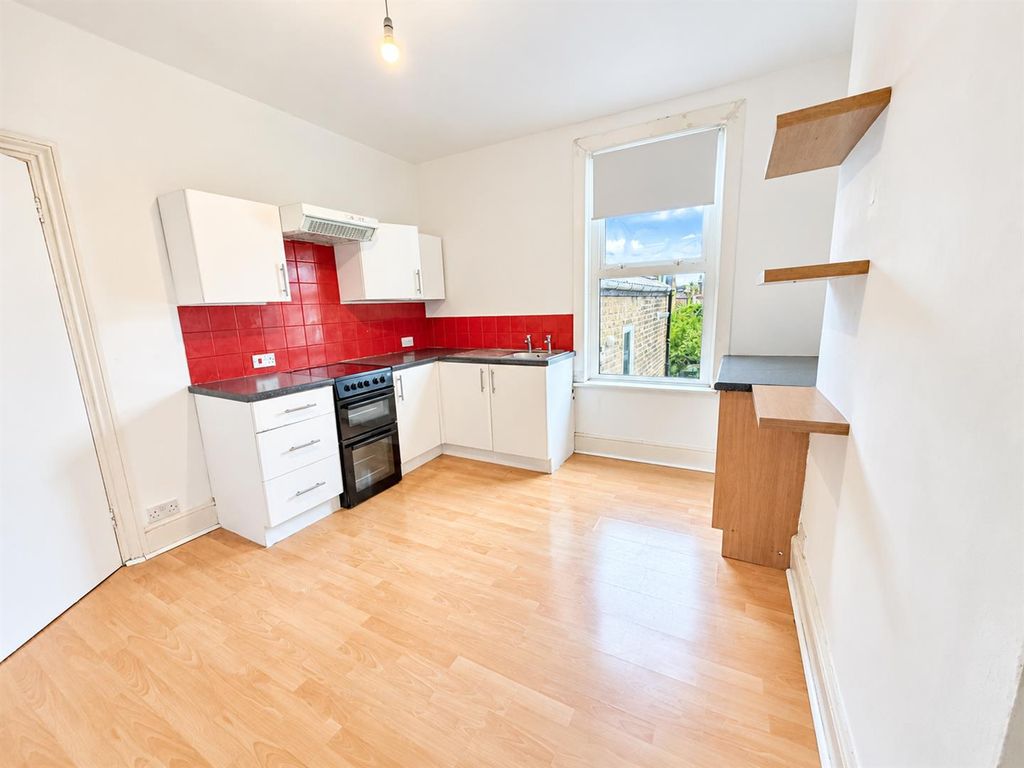Property photo 2 of 10 Bright Modern Kitchen With Red Tile Backsplash.Png