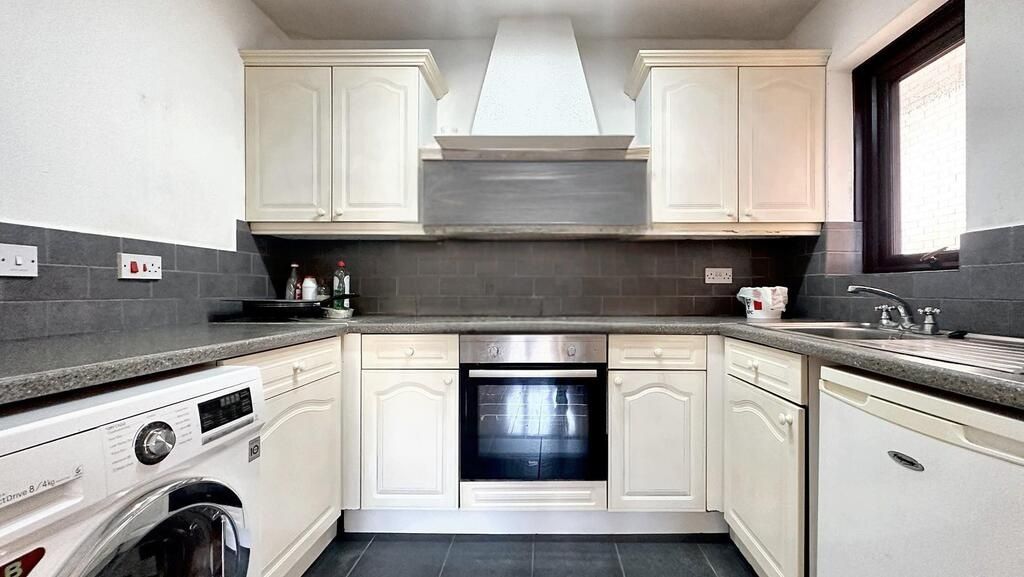 Property photo 1 of 6 Bright, Modern Kitchen With White Cabinetry, Integ...