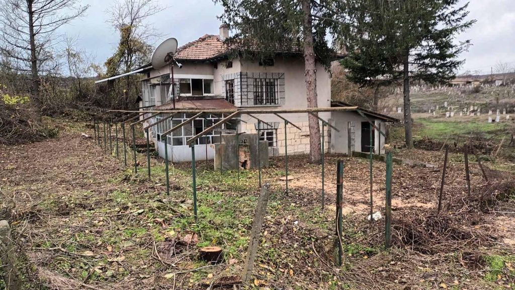 Property photo 1 of 25 View Of The Two-Storey House With A Tiled Roof, Enclosed Porch, And Garden Space With Trees And Fencing