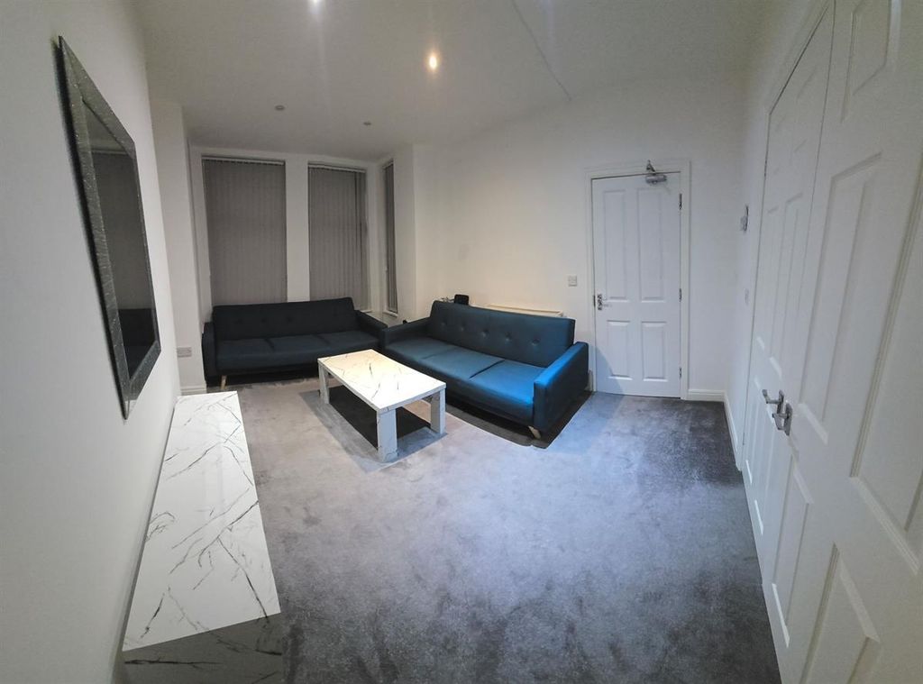 Property photo 1 of 13 A Spacious, Modern Living Room Featuring Contempor...