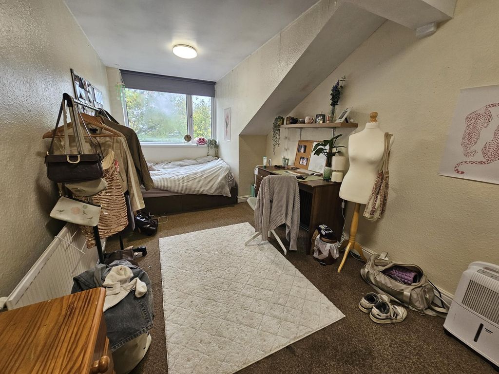 Property photo 3 of 18 A Cozy Bedroom With A Large Window Providing Natur...