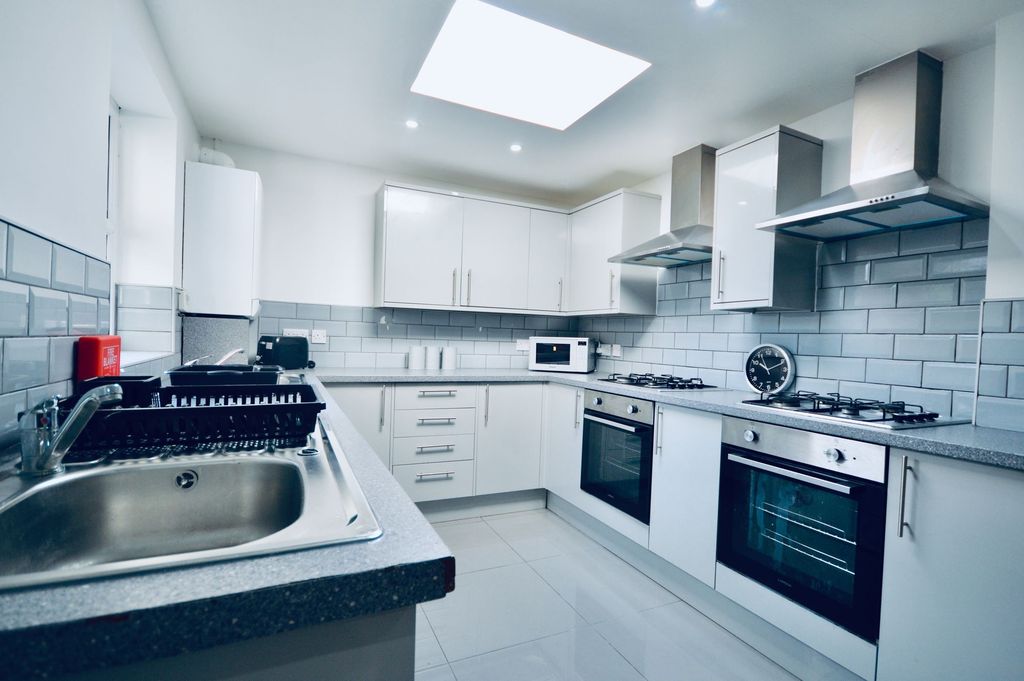 Property photo 2 of 4 A Modern, Bright Kitchen Featuring White Cabinets,...