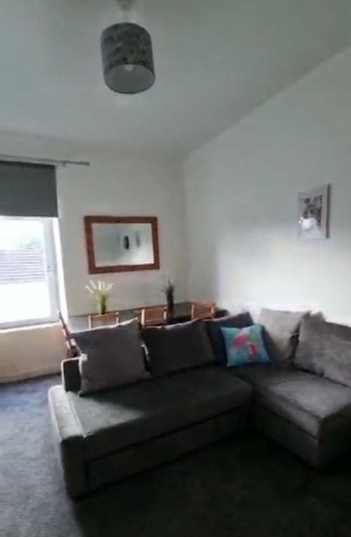 Property photo 1 of 7 Bright Living Room Featuring A Comfortable Grey L-...
