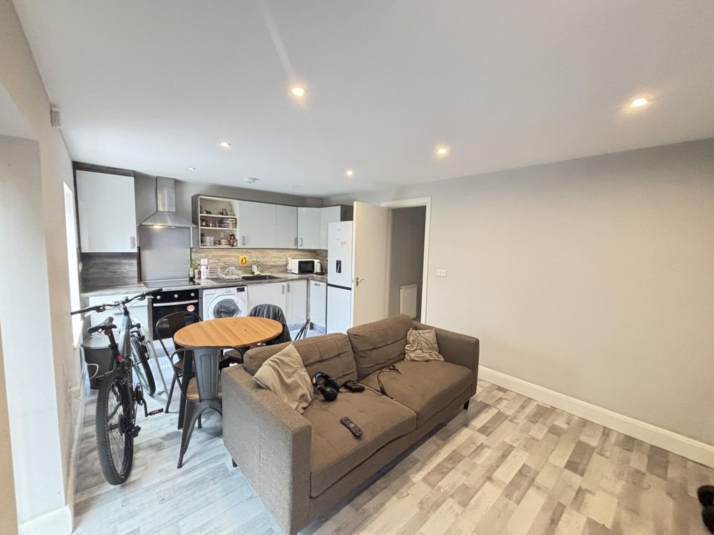 Property photo 3 of 8 A Bright And Modern Living Room Featuring A Comfor...