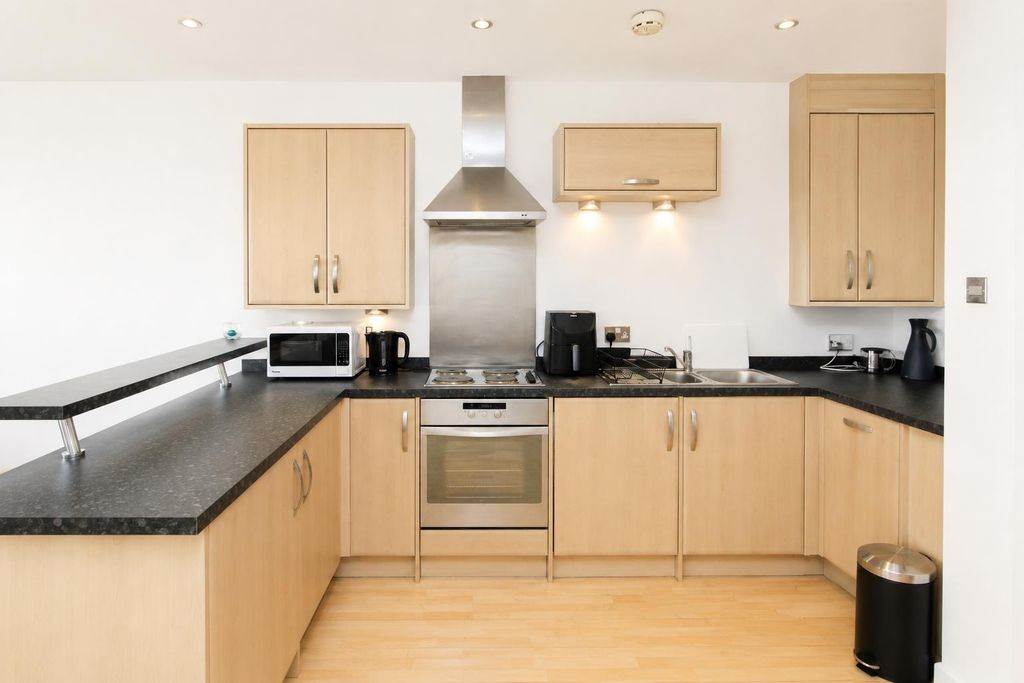 Property photo 3 of 9 Sleek Modern Kitchen With Ample Counter Space...