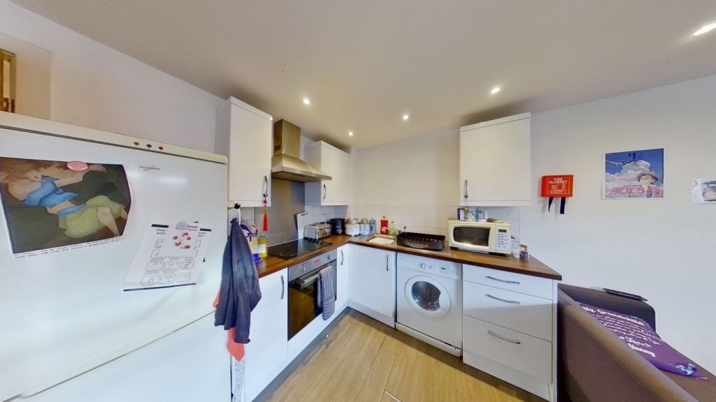 Property photo 2 of 5 Bright And Modern Kitchen Featuring White Cabinetr...
