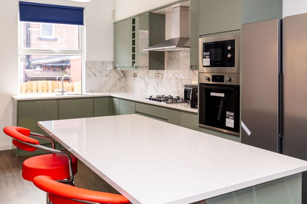 Property photo 1 of 9 Modern Kitchen Featuring Sleek Green Cabinetry, A ...