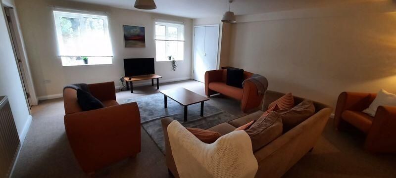 Property photo 2 of 11 A Spacious And Well-Lit Living Room Featuring Comf...