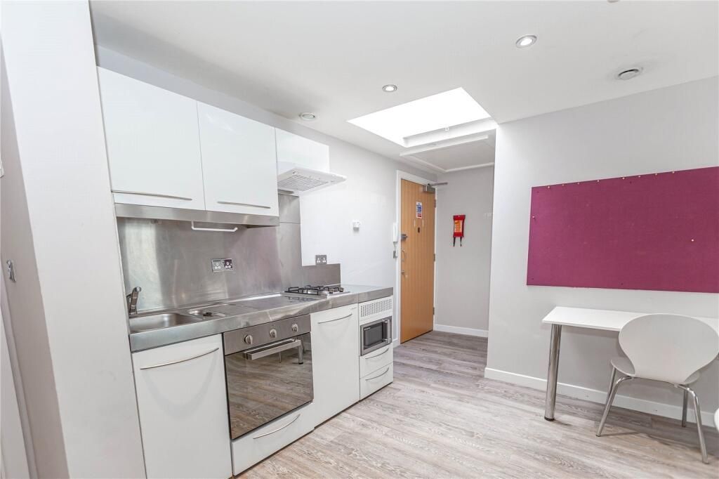 Property photo 2 of 4 Bright And Modern Kitchen Area Featuring Sleek Whi...