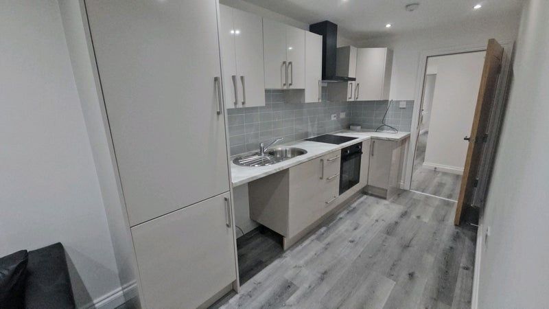 Property photo 1 of 6 Modern Galley Kitchen Featuring Sleek Cabinetry, i...