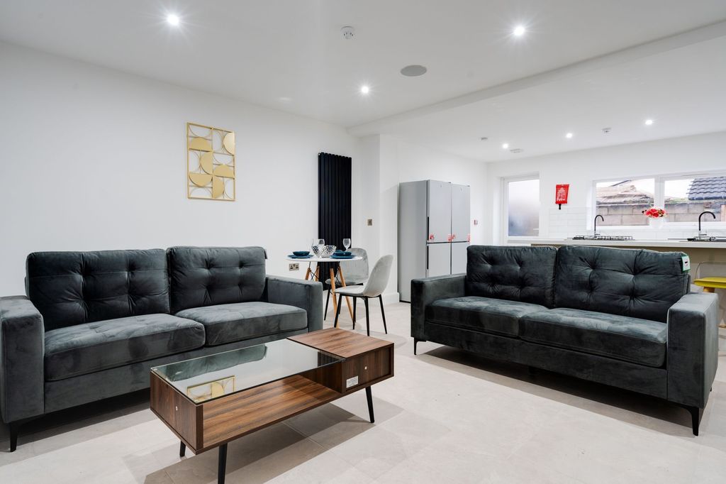 Property photo 2 of 6 Modern And Stylish Living Room Featuring Two Black...