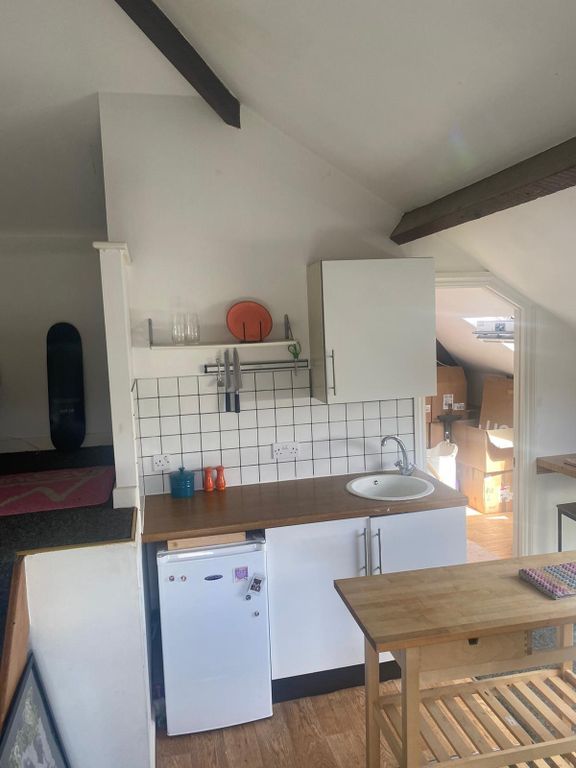 Property photo 2 of 5 Compact Kitchenette With White Cabinetry, Wood-Eff...