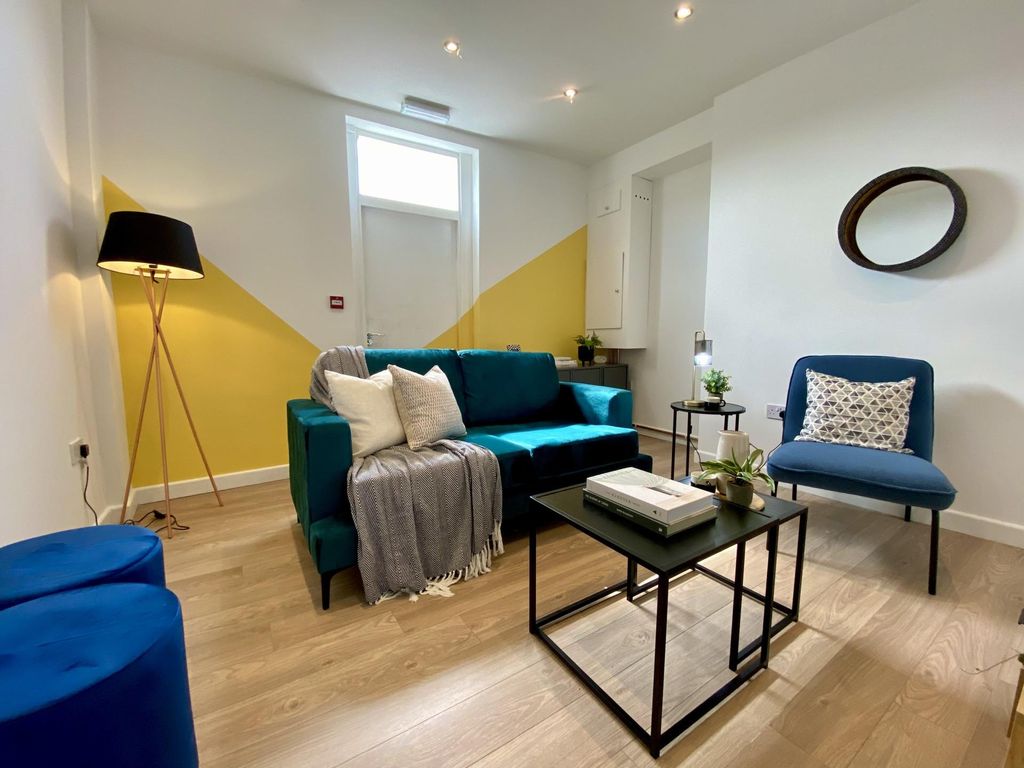 Property photo 1 of 4 Bright And Inviting Living Room Featuring A Stylis...