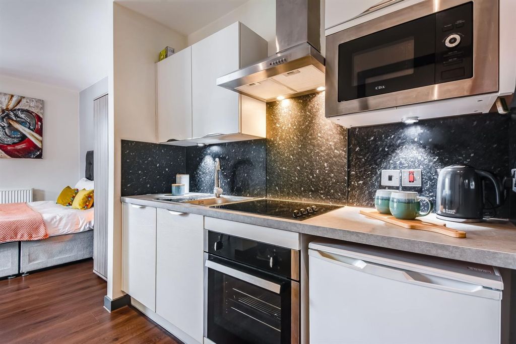 Property photo 2 of 6 Modern Studio Kitchen With Stylish Dark Splashback...