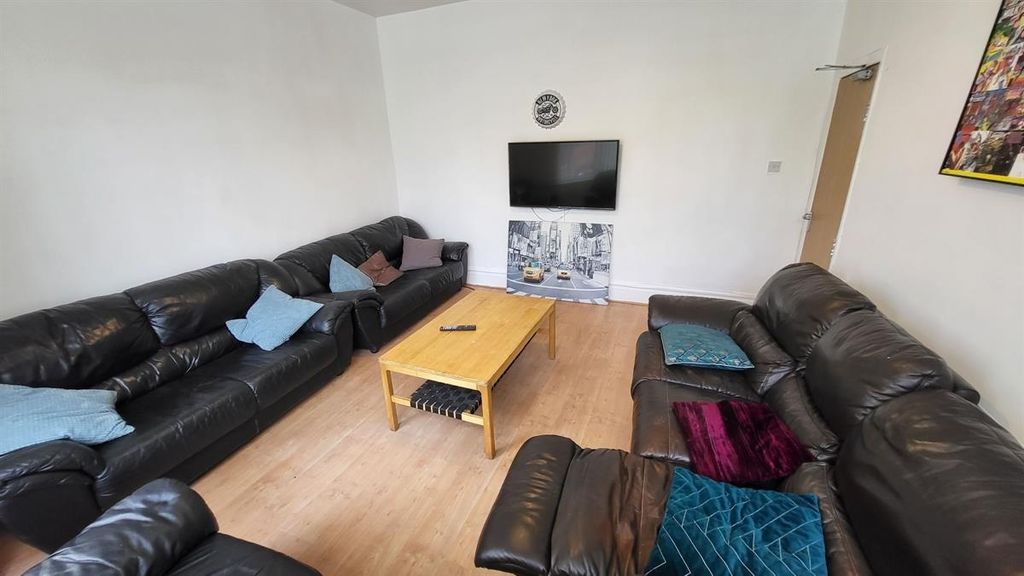 Property photo 2 of 15 A Cozy Living Room Featuring Multiple Large Black ...