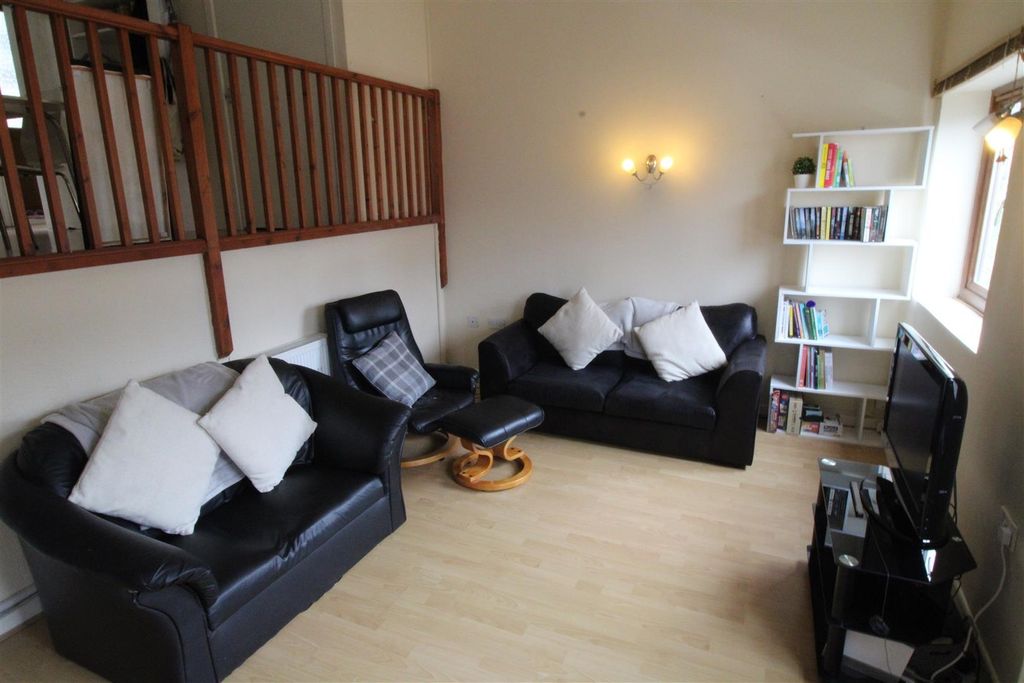 Property photo 1 of 7 Bright Living Room With Ample Seating And Storage...