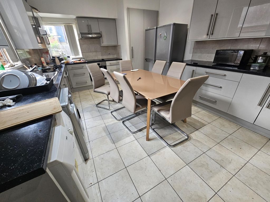 Property photo 3 of 21 A Clean And Well-Lit Modern Kitchen With White Cab...