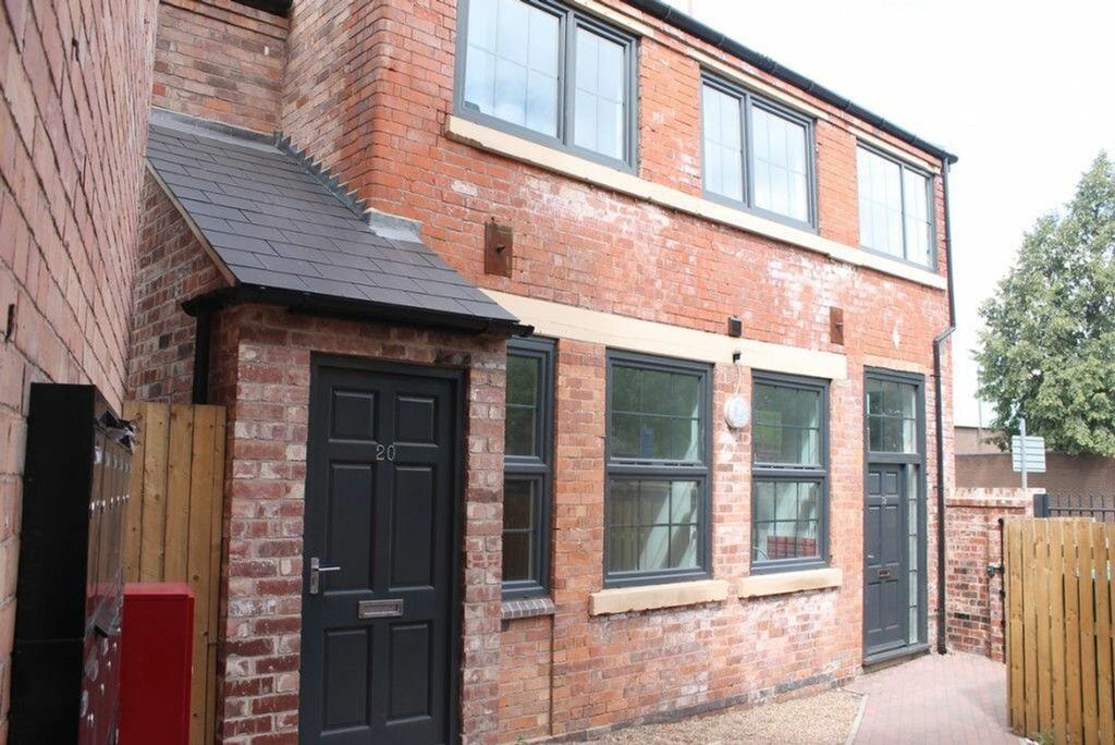 Property photo 3 of 6 A Charming Red-Brick Facade Featuring Large Window...