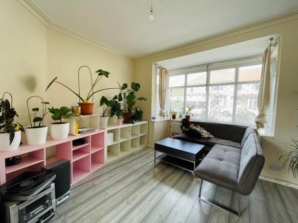 Property photo 3 of 12 Bright And Modern Living Room Featuring A Large Wi...