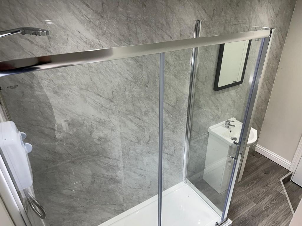 Property photo 3 of 9 Modern Bathroom Featuring A Sleek Shower Enclosure...