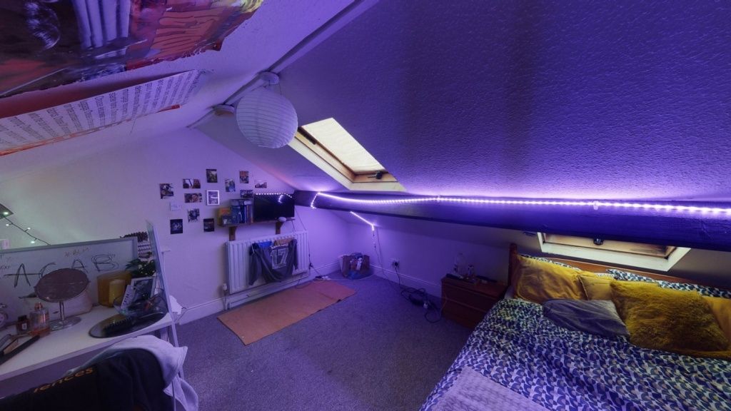 Property photo 1 of 7 A Cozy And Stylish Attic Bedroom Featuring A Comfo...