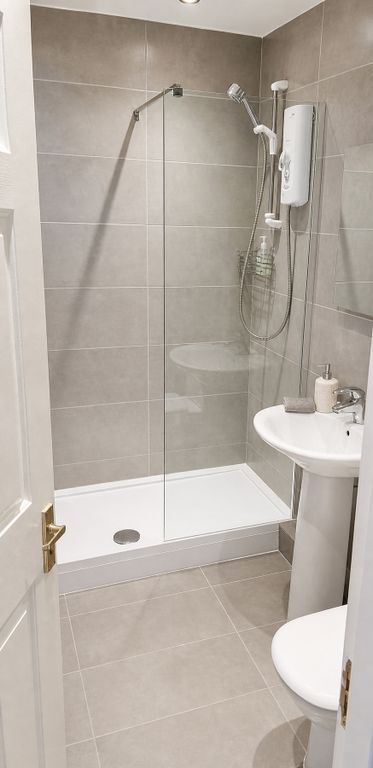 Property photo 3 of 7 Modern Tiled Bathroom With A Sleek Glass Shower....