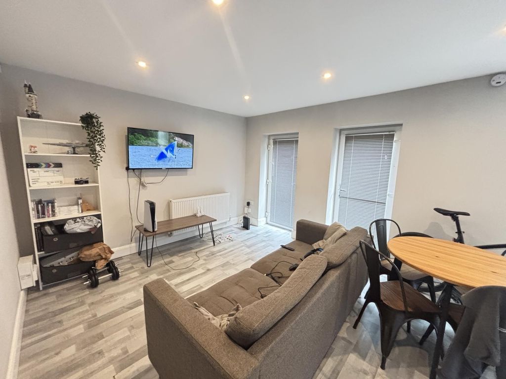 Property photo 2 of 8 A Bright And Airy Living Room Featuring Modern Fur...