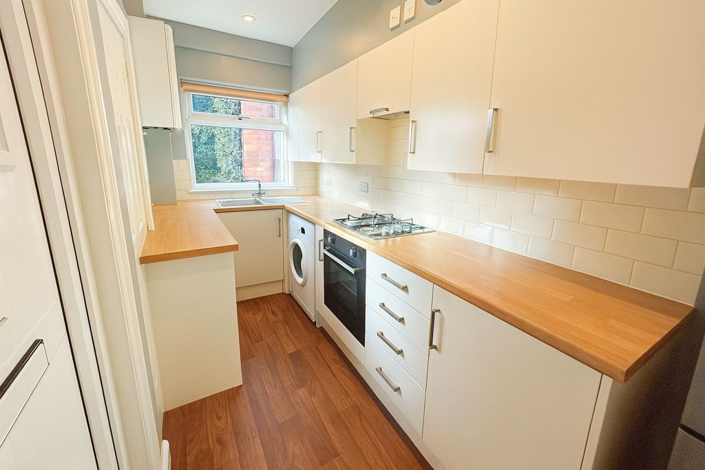Property photo 1 of 8 Bright Modern Galley Kitchen With Wooden Counterto...