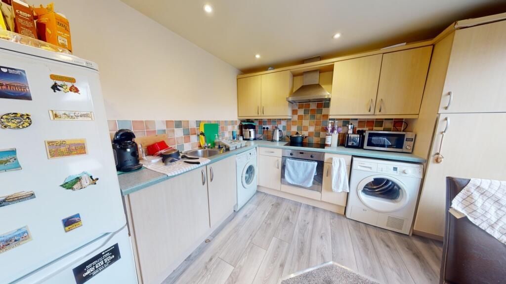 Property photo 3 of 6 Bright, Modern Kitchen With Ample Storage And Inte...