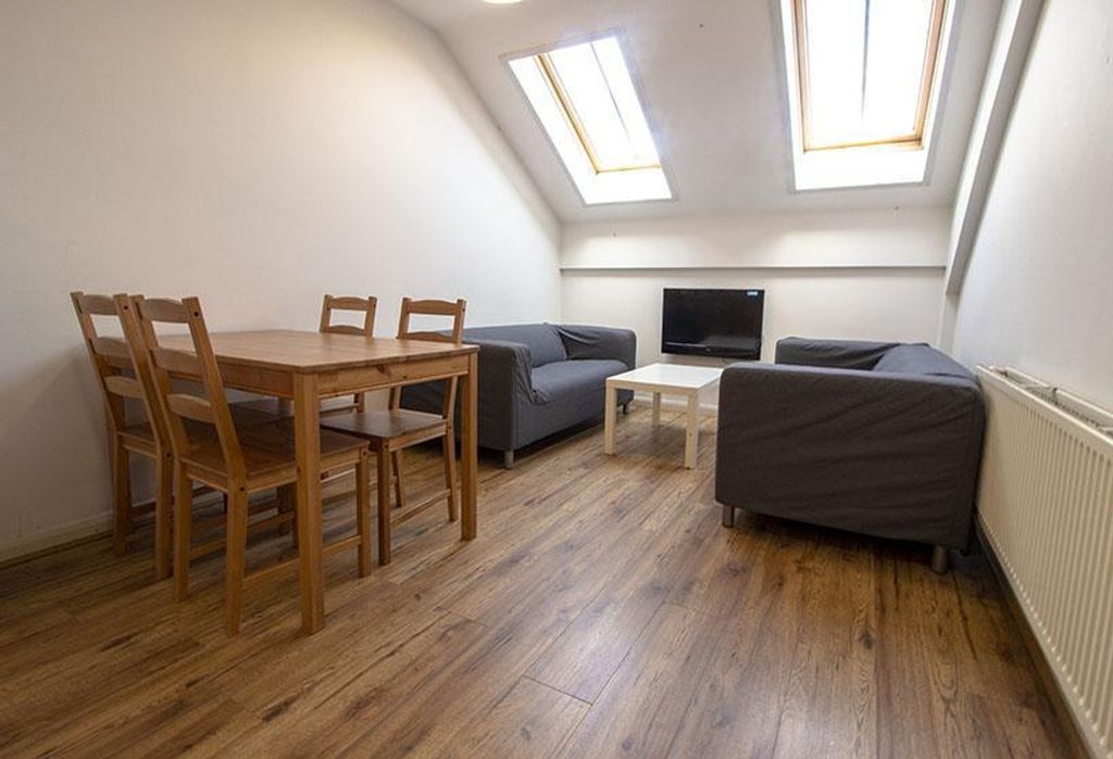Property photo 1 of 7 A Cozy Living Room Featuring Ample Natural Light F...