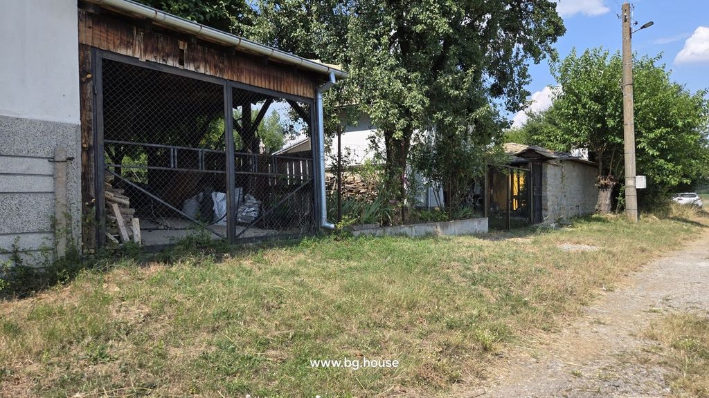 Property photo 3 of 99 Covered Outdoor Storage Area With Wood Piles And Fenced Garden Alongside A Rural Dirt Road