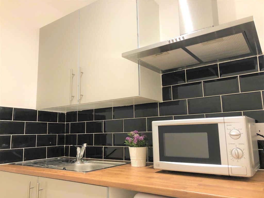 Property photo 3 of 7 Modern Kitchen Featuring Sleek Black Subway Tile B...